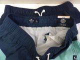blue and green swim shorts with a white star on the side