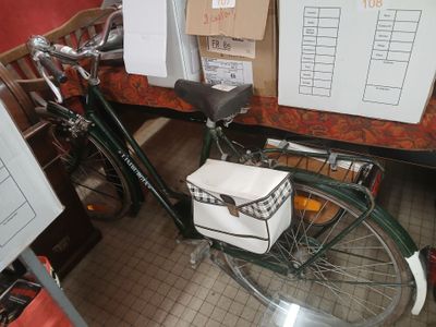 a bike that is parked in a room with a lot of boxes on the wall