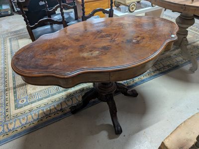 a table with a wooden top on a rug in a room