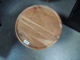 a round wooden table with a label on it