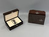 an open box with a watch inside of it sitting on a table