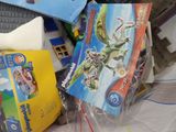 a pile of toys and books on a table