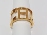 a white napkin with a gold plated ring on it