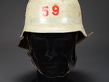 an old helmet with a number on it sitting on a mannequin head