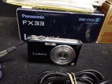 a black camera sitting on a table next to a pair of scissors
