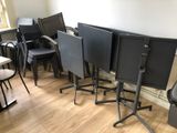 many chairs and tables in a room with wood flooring