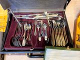a case with a bunch of silver spoons in it