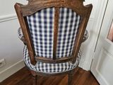 a blue and white checkered chair in the corner of a room