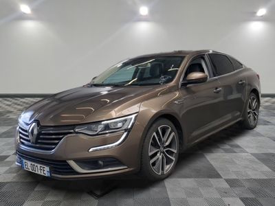 La voiture marron est garée sur un sol à damier dans une pièce