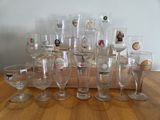 a lot of wine glasses sitting on a wooden table