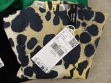 a black and yellow leopard print bag with a price tag on it