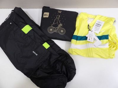 two pairs of pants and a shirt are on a table