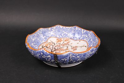 an image of a blue and white bowl on a black surface