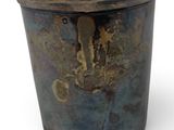 a metal pot that has a rusted surface on it