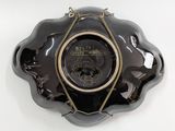 a black and gold plate with a masonic emblem on it