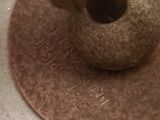 a close up of a metal object on a tile floor