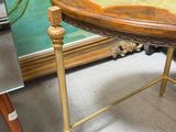 a table that has a painting on the wall behind it