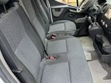 the interior of a van with four seats and a steering wheel