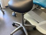 a blue and white chair and a white chair in a room