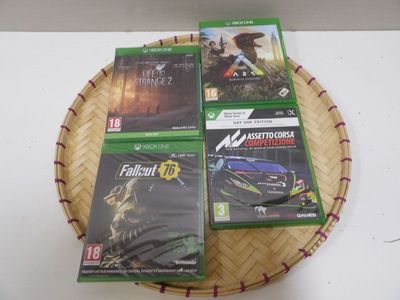 four video games on a basket on a table