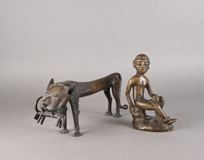 des figurines en bronze représentant un garçon et un chien assis sur un banc