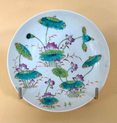 a white plate with blue flowers and green leaves on it