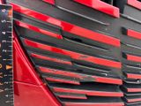 a close up of a red truck with a ruler on it ' s side