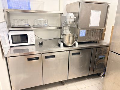 a kitchen with stainless steel cabinets and a mixer on the counter