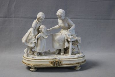 two figurines of women sitting on a table