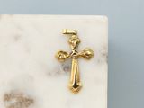 an image of a gold cross on a white marble block
