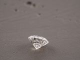 a close up of a diamond on a table with a blurry background