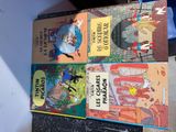 four children ' s books sitting on top of each other