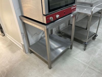 two microwaves that are sitting on top of each other