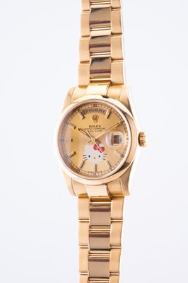 an image of a hello kitty watch on a gold bracelet