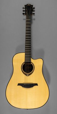 a small acoustic guitar on a gray background