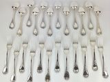 a lot of forks and spoons that are on the table