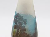 a vase with a painting on it on a white surface