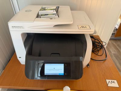 a printer sitting on top of a desk next to a banana