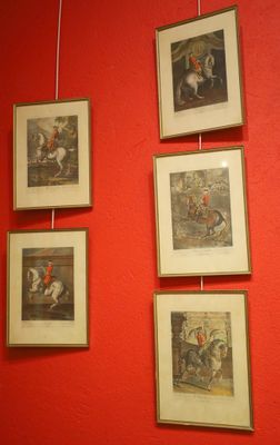 pictures hanging on the wall of a room with red walls