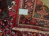 a close up of a rug with a tag on it