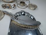 a lot of silver items on a table with a mirror