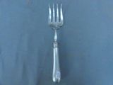 a silver fork and a silver spoon on a blue surface