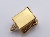 an image of a gold plated metal clasp on a white surface