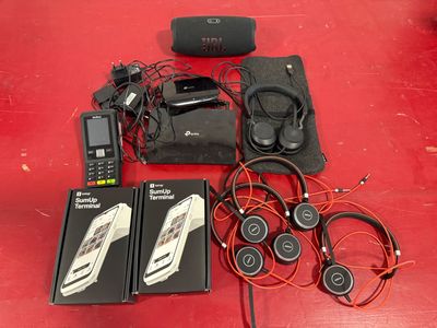 a red table with a bunch of electronics on it
