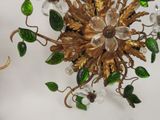 a gold and green chandelier hanging from the ceiling