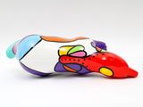 brightly colored fish figurine on a white surface with a white background