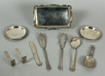 a lot of silver spoons and knives and a mirror