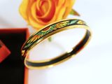 a yellow rose and a black box with a ring on it