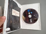 someone is holding a dvd in a case with a cd inside of it