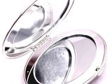 a compact mirror sitting on top of a white surface